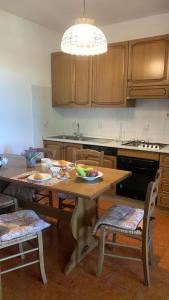 a kitchen with a table with a bowl of fruit on it at valle del paradiso 9 in Seggiano
