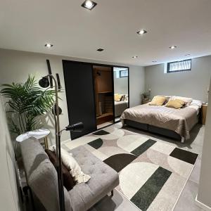 a bedroom with a bed and a couch at Ground floor apartment near the sea, golf, lake, and forest in Hovås
