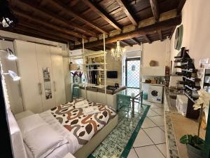 a bedroom with a large bed and a kitchen at Your nest in Trastevere, the heart of Rome - Il vostro Nido nel cuore di Roma in Rome