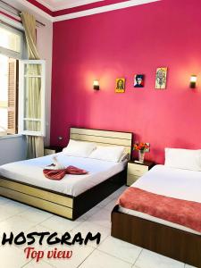 A bed or beds in a room at Hostgram Top View