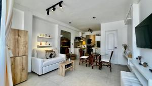 a living room with a white couch and a table at Apartamentos Boho in Punta Hermosa