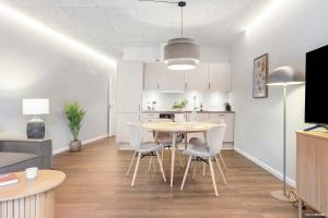 a kitchen and dining room with a table and chairs at City Central Apartment w Modern Nordic Interiors in Aarhus