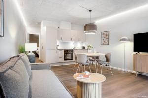 a living room with a couch and a table at City Central Apartment w Modern Nordic Interiors in Aarhus +31 photos