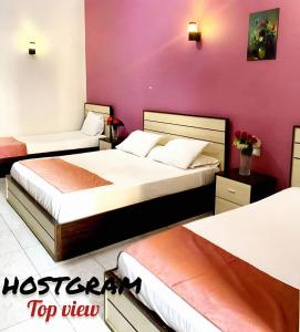 A bed or beds in a room at Hostgram Top View