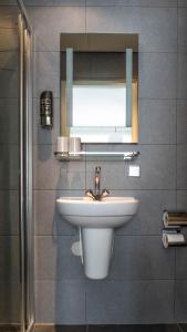 a bathroom with a sink and a mirror at B&B House No 7 in Amsterdam