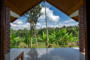 a room with a window with a view of a forest at Organic Rice Harmony in Tetebatu