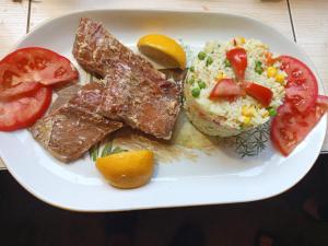 a plate of food with eggs rice and tomatoes at Camp River in Virpazar