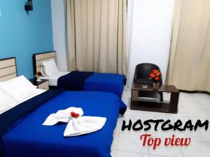 A bed or beds in a room at Hostgram Top View