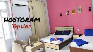 A bed or beds in a room at Hostgram Top View