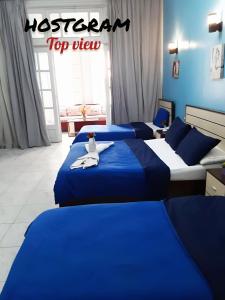 A bed or beds in a room at Hostgram Top View