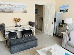 a living room with a desk and a couch at Moat Stays Victorian, Sea View! in Kent