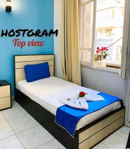 A bed or beds in a room at Hostgram Top View