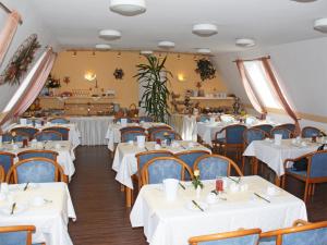 ミヒェルシュタットにあるCity Hotel Mark Michelstadtのダイニングルーム(白いテーブル、椅子付)