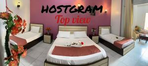 A bed or beds in a room at Hostgram Top View