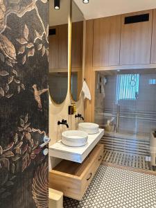 a bathroom with two sinks and a shower at Alpine Oasis - Silver Mountain in Poiana Brasov +6 photos