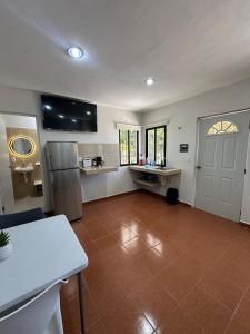 a kitchen with a refrigerator and a table in a room at Oneira Seybaplaya apartments private and exclusive in Seybaplaya