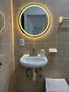 a bathroom with a sink and a mirror at Oneira Seybaplaya apartments private and exclusive in Seybaplaya