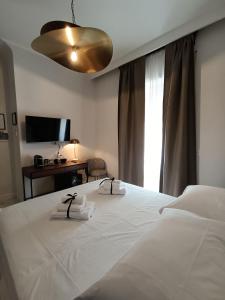 a bedroom with a bed with two towels on it at Luxury Rome Vatican's Garden in Rome