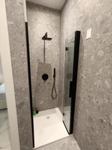 a shower with a glass door in a bathroom at Luxury Rome Vatican's Garden in Rome