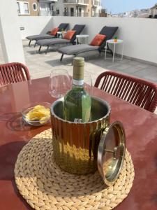 a bottle of wine in a bucket on a table at Boutique Style Town House in Albufeira