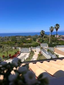 a view of a building with the ocean in the background at Appartamento Costa degli Dei in Tropea