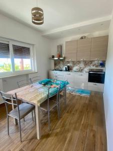 a kitchen with a table and chairs in a room at Appartamento Costa degli Dei in Tropea