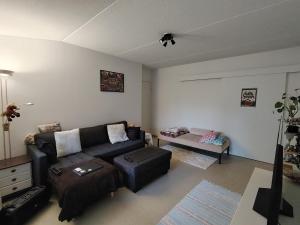 a living room with a couch and a table at Parkstad Home Base in Helsinki
