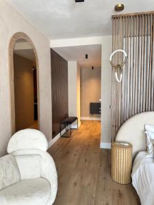 a bedroom with a bed and a couch and a table at Alpine Oasis - Silver Mountain in Poiana Brasov