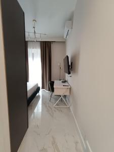 a white room with a desk and a bed at Luxury Rome Vatican's Garden in Rome
