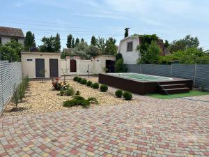 a backyard with a swimming pool and a brick driveway at House in Karolino-Buhaz in Zatoka