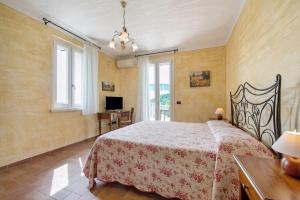a bedroom with a bed in a room with windows at Agriturismo Il Cardo in Soiano del Lago