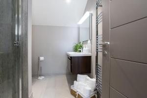 a bathroom with a sink and a mirror at Curlew Loft in Lancaster +30 photos