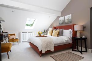 a bedroom with a large bed with a red headboard at Curlew Loft in Lancaster