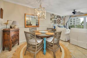 a dining room with a table and chairs and a living room at Sail Inn SaintSimons-ground unit beach access pool in East End