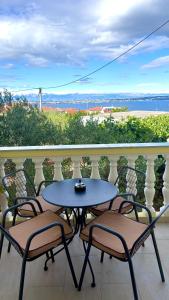 a table and chairs on a balcony with a view at Modern apartment Kali - with panoramic view in Kali