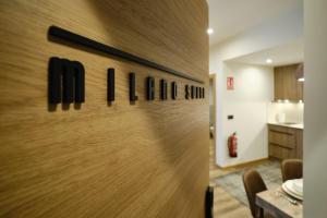 a dining room with a wooden wall with the name of a restaurant at IL FOCOLARE Premium Suites in Avilés