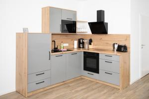 a kitchen with white cabinets and a counter top at Klosterhof Aue W 14 in Bad Zwischenahn +8 photos