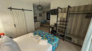 a room with a bed and a desk and a door at Aliston Hotel Thassos in Skala Potamias