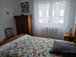 a bedroom with a bed and a window at Le Nid du Bocage in Sevremont