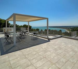 a pavilion with a table and chairs on a patio at Villa Caravaggio Comfort e Relax in Rocca San Giovanni