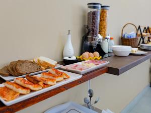 a buffet with bread and eggs on a table at Villa Caravaggio Comfort e Relax in Rocca San Giovanni
