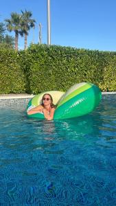 a woman is laying in an inflatable at by Osibov, holiday home near Split with pool in Kaštela