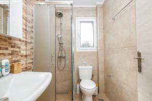 a bathroom with a shower and a toilet and a sink at Corfu Blue Memories Apartment 2 in Corfu Town +22 photos