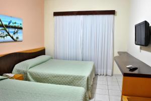 Et tv og/eller underholdning på Hotel Areia de Ouro