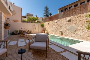 a courtyard with a swimming pool in a house at Vila Nova Suites & SPA in Capdepera