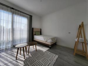 a bedroom with a bed and a table and a chair at Villa Da London in Dalaman +12 photos