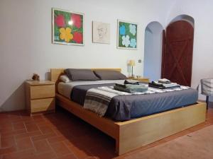 a bedroom with a bed with a wooden frame at Suite Monamea in Pian di Scò