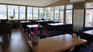 a restaurant with tables and chairs and windows at ÜSKÜDAR OTEL in Istanbul