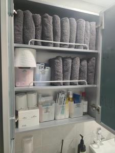 a medicine cabinet filled with rolls of toilet paper at Stay Chic 황리단길 룸3 침대5 에어컨4 에어랩 건식사우나 동궁과월지 in Gyeongju +32 photos