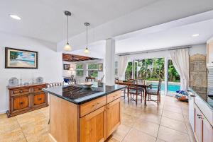 a kitchen and dining room with a table and chairs at Casa Balsinde - Delight in a Private Pool in the Southern End of West Palm in West Palm Beach
